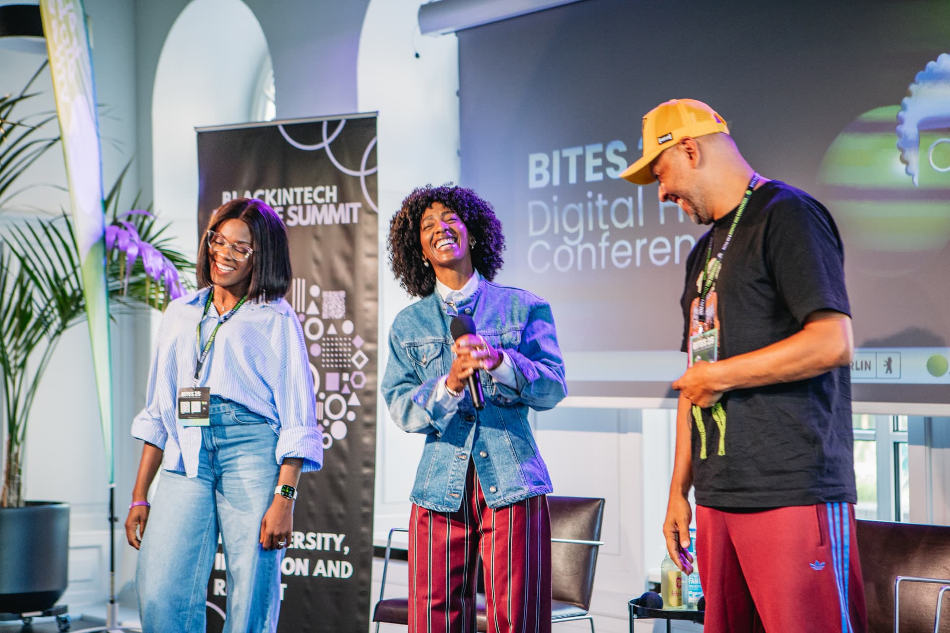 Hosts laughing together on the BITES stage